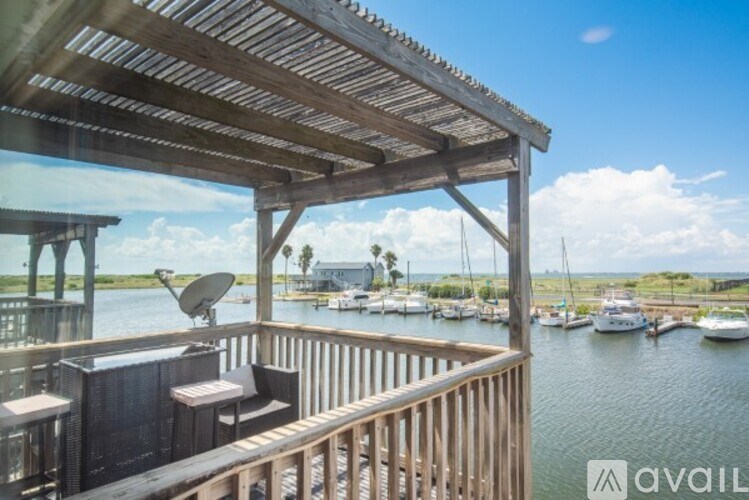 A wooden deck overlooking a marina with boats.
