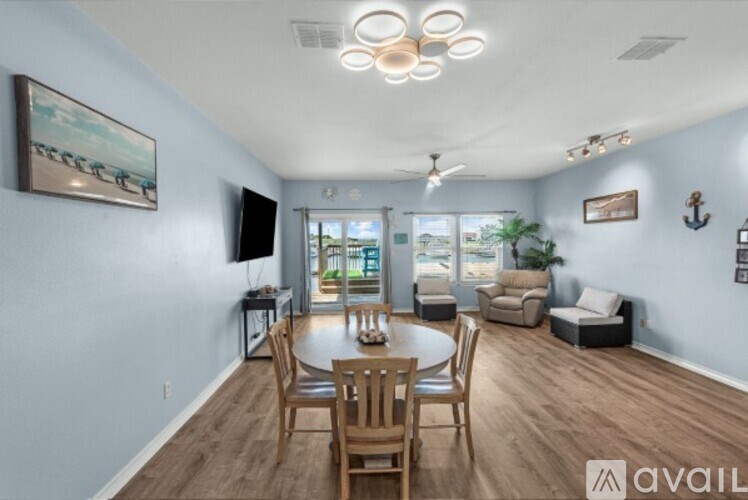 A living room with a dining table and chairs.