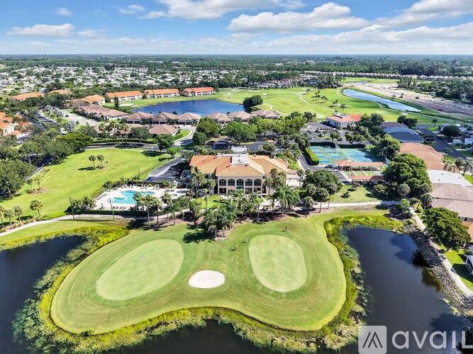 A golf course with a clubhouse and water features.