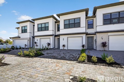 A row of three houses with white exteriors and dark roofs.