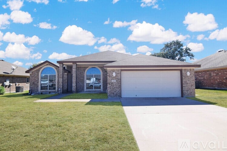 A house with a garage and a driveway is available for sale.
