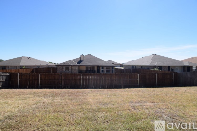 A row of houses with a fence in front of them.