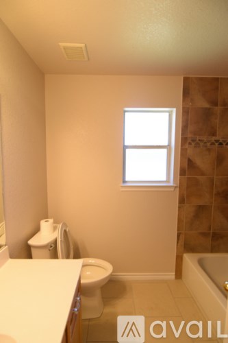 A bathroom with a toilet, sink, and tub.