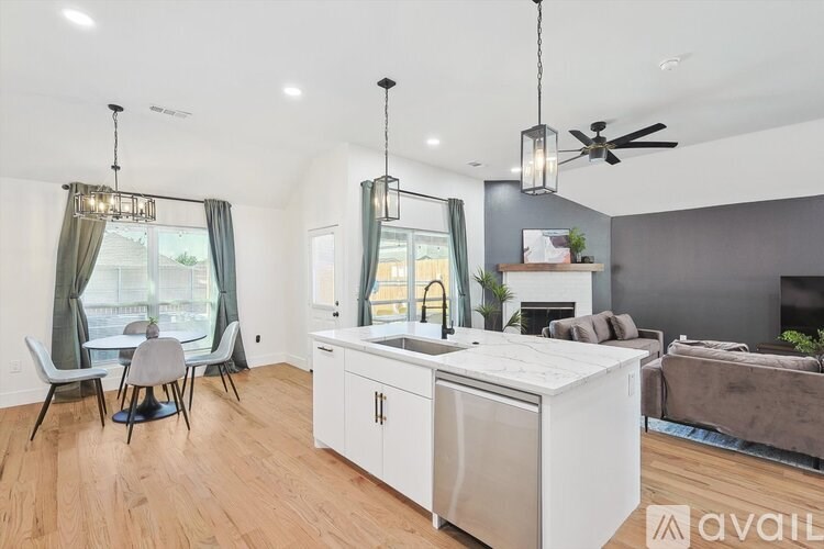 A modern kitchen with a dining table and chairs.