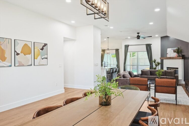 A modern living room with a long wooden table and chairs.