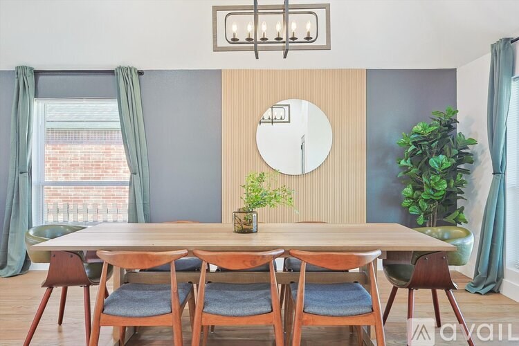 A dining room with a wooden table and chairs.