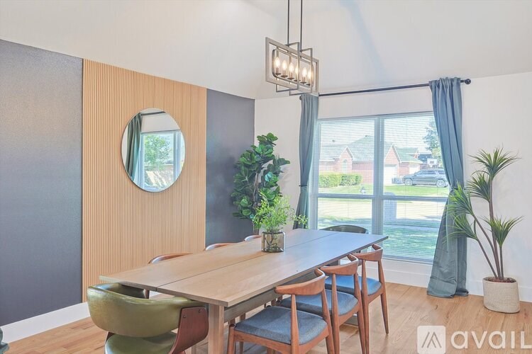 A dining room with a wooden table and chairs.