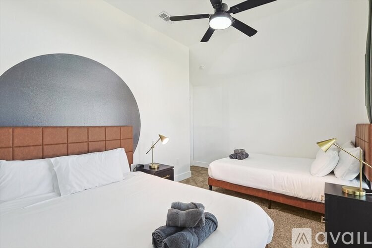 A bedroom with a large bed and a smaller bed in the corner.