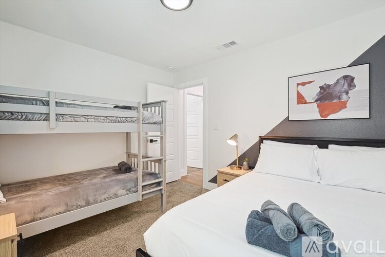 A bedroom with a bunk bed and a single bed.