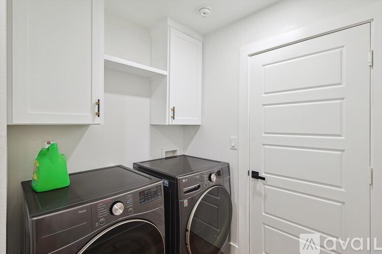A washing machine and dryer in a laundry room.