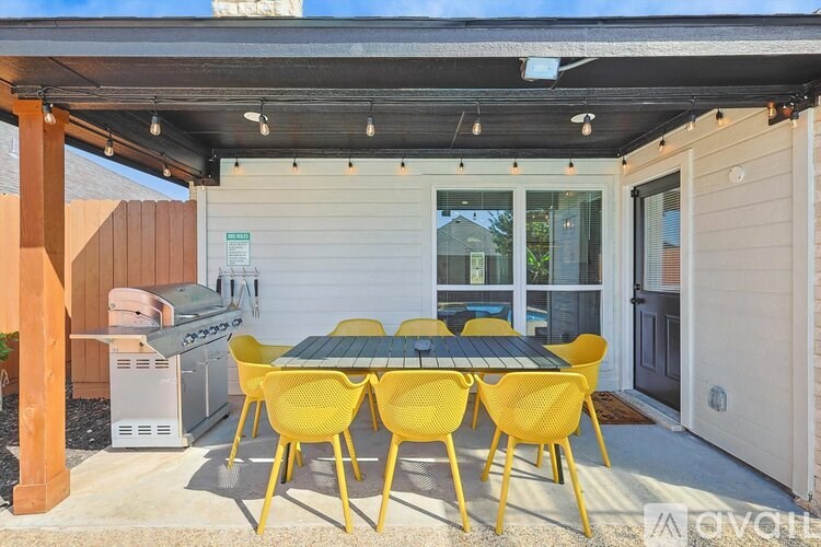 A patio with a table and chairs is shown.