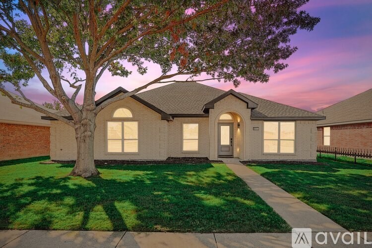 A house with a tree in front of it is available for sale.