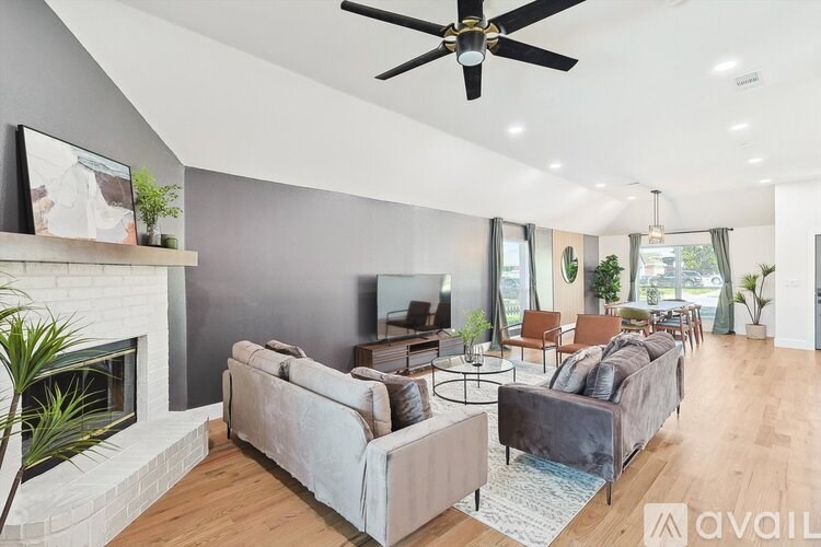 A modern living room with a fireplace and a large couch.