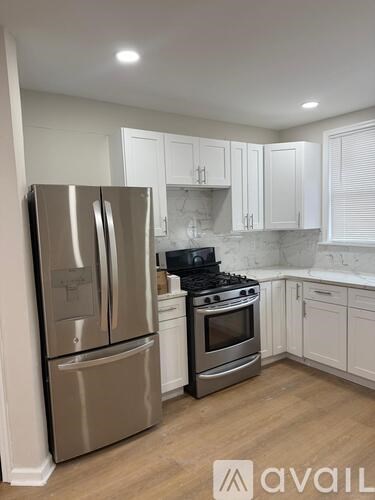A kitchen with a stainless steel refrigerator and stove.