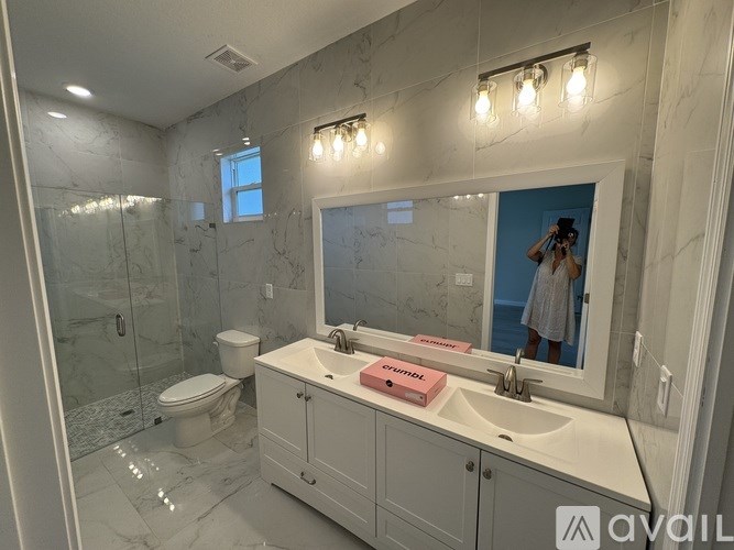 A bathroom with a sink, mirror, and toilet.