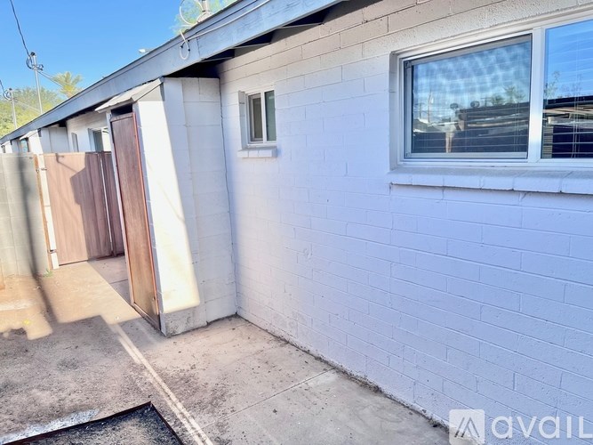 A white house with a brown door and a window.