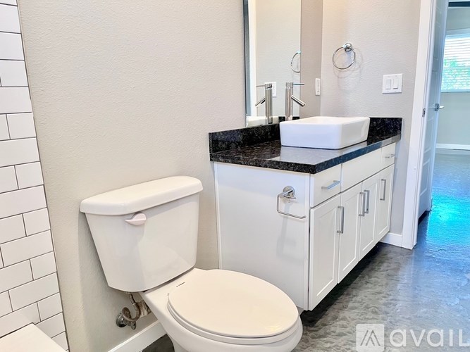 A white toilet sits next to a sink in a bathroom.