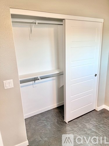 A white door is open to a small laundry room.