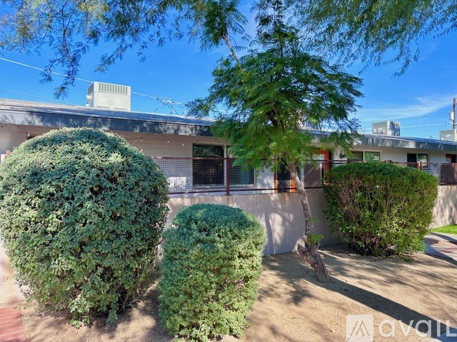 A house with a well-maintained garden in front.