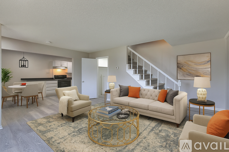 A spacious living room with a staircase leading to the upper floor.
