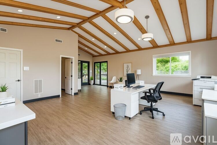 A white car is parked in a parking lot in front of a building.