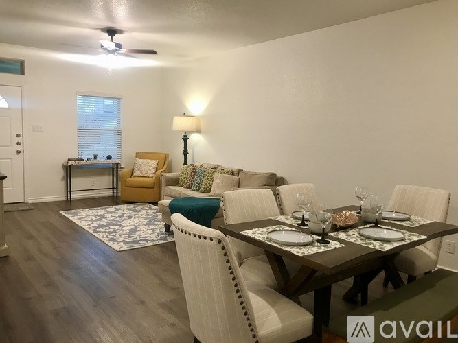 A dining room with a table set for four.