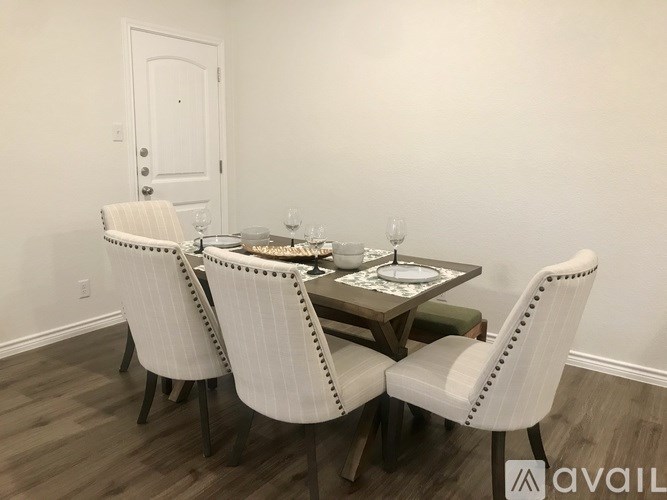 A dining room with a table set for two.