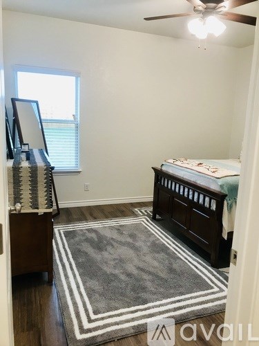 A baby's room with a crib and a rug.