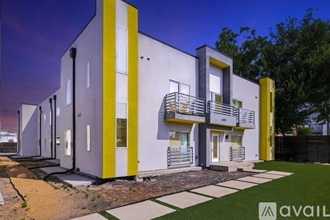 A modern building with a white and yellow exterior is available for purchase.
