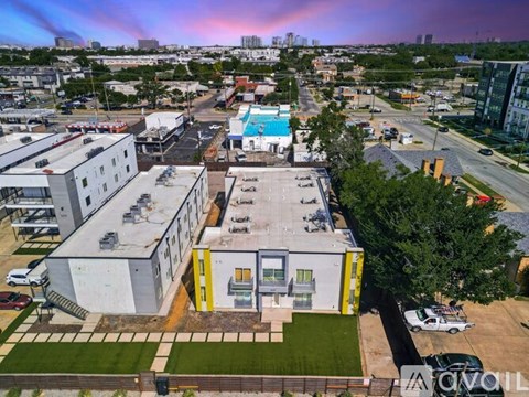 A yellow and white building is in the foreground of a cityscape.
