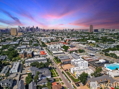 A cityscape with buildings and a swimming pool in the foreground.