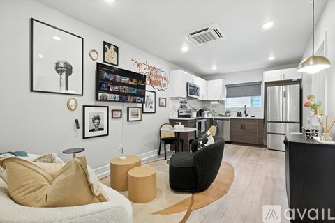 A living room with a white couch and a black chair.