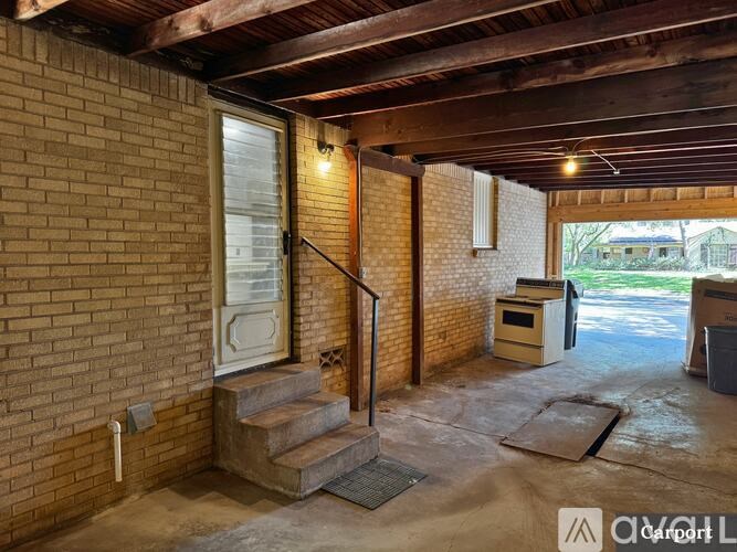 A room with a brick wall and a concrete floor.