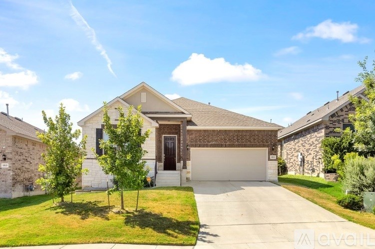 A house with a garage and a driveway in front of it.