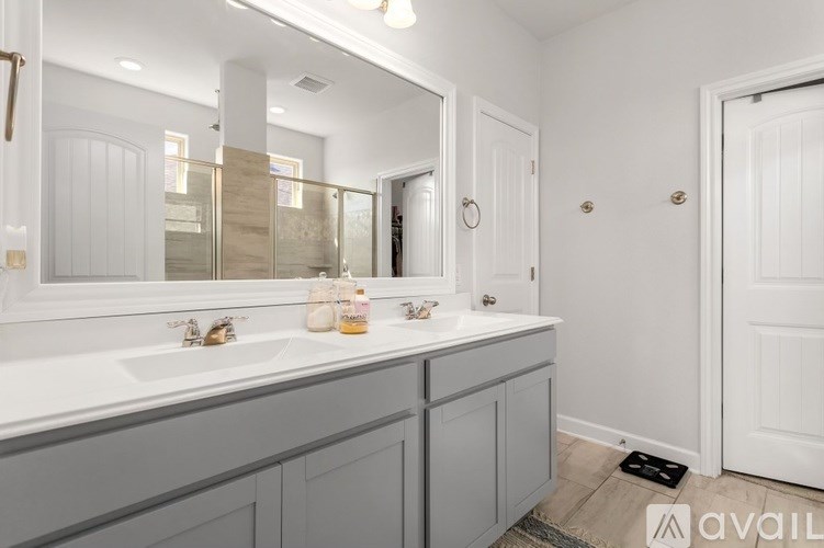 A bathroom with two sinks and a large mirror.