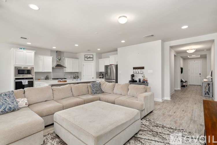 A spacious living room with a large sectional sofa and a coffee table.