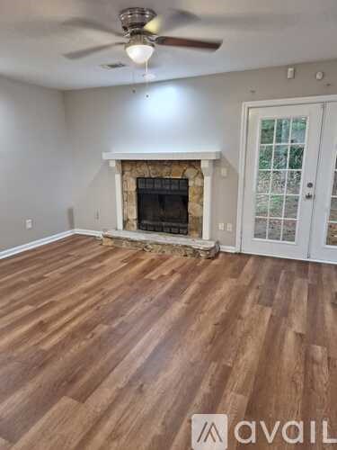 A room with a fireplace and a ceiling fan.