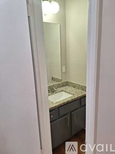 A bathroom with a sink and mirror.