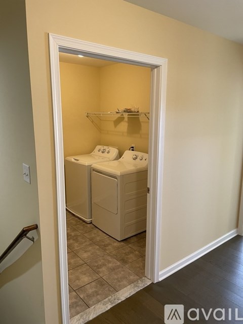 A bathroom with a toilet and a washing machine in it.