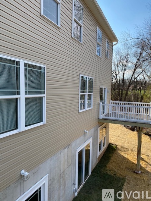 A house with a balcony and multiple windows.