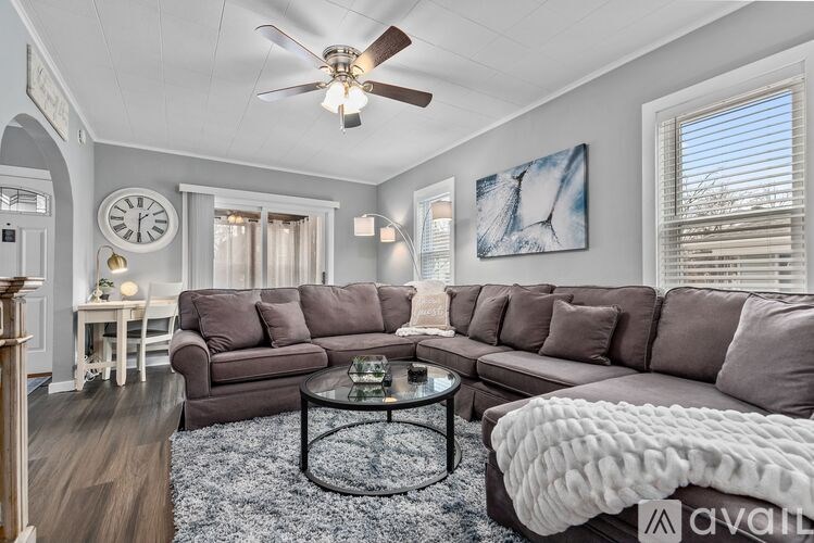 A living room with a grey couch and a coffee table.