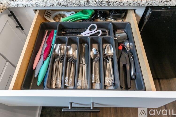 A drawer full of silverware and utensils.