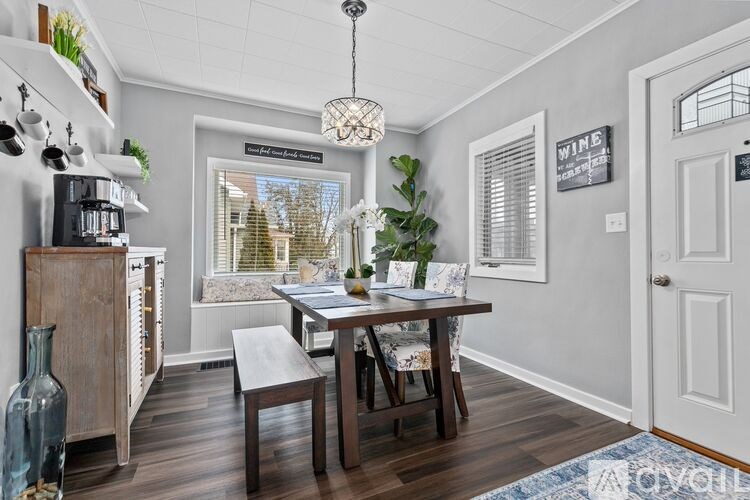 A dining room with a wooden table and chairs.