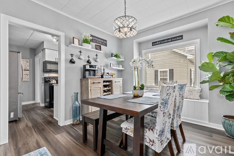 A dining room with a wooden table and chairs.