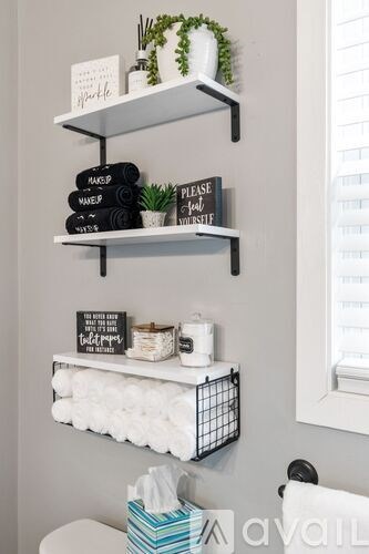 Bathroom with white shelves and towels.