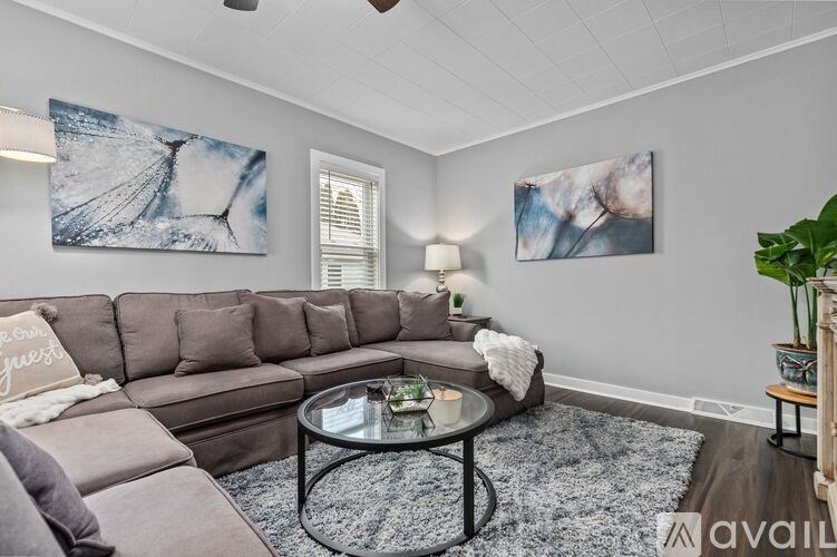 A living room with a grey sofa and a coffee table.