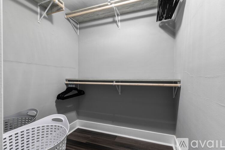 A small, empty room with a shelf and a laundry basket.