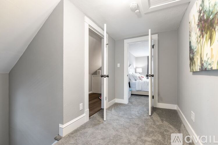 A bedroom with a bed, dresser, and mirror.