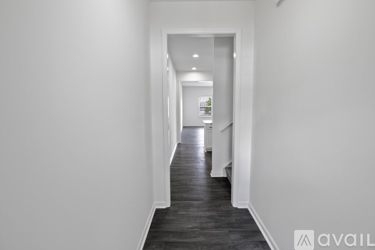 A long hallway with a door at the end.