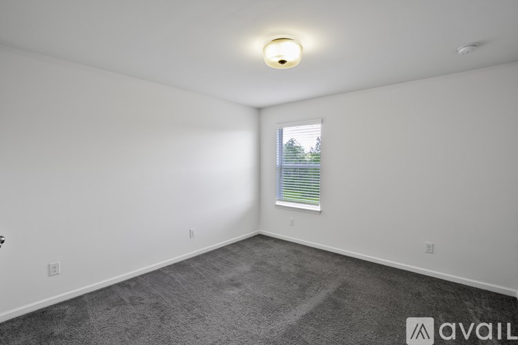 A room with a window and a ceiling light.